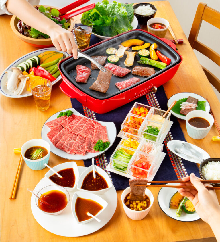 食卓で焼肉をする様子