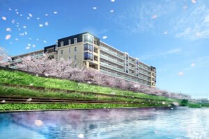 マンション開発事業。桜が咲く川沿いの近くに建つマンション